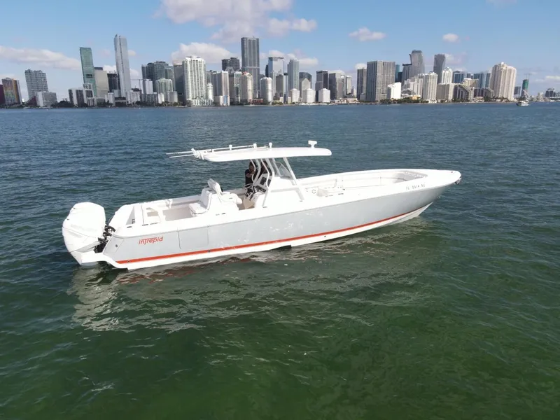 Slide: The Image of 2016 Intrepid 375 CC boat on water with city skyline in background. - 1