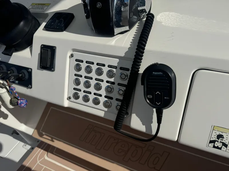 Slide: The Image of Control panel of a 2016 Intrepid 375 CC boat with radio and switches. - 15