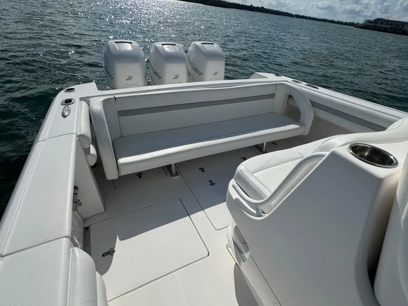 Slide: The Image of 2016 Intrepid 375 CC boat with spacious seating and triple outboard engines on the water. - 25