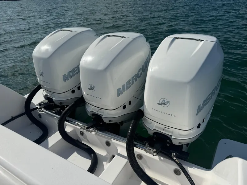 Slide: The Image of Triple Mercury outboard engines on a 2016 Intrepid 375 CC boat, docked on water. - 28