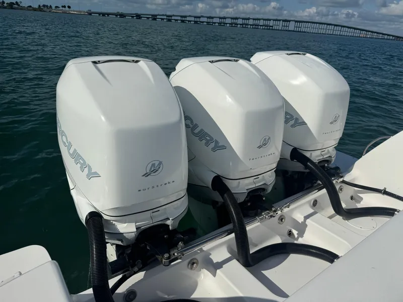 Slide: The Image of Triple Mercury outboard engines on a 2016 Intrepid 375 CC boat in open water. - 29