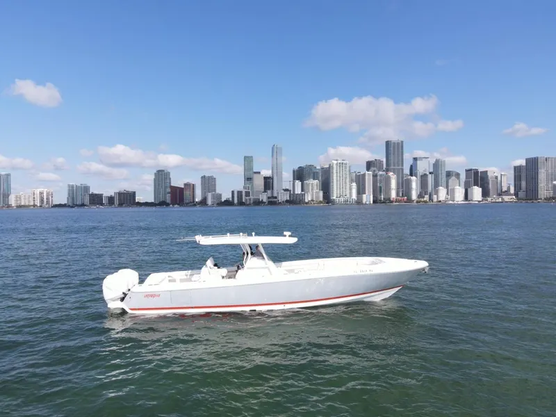 Slide: The Image of 2016 Intrepid 375 CC boat on water with city skyline in background. - 3