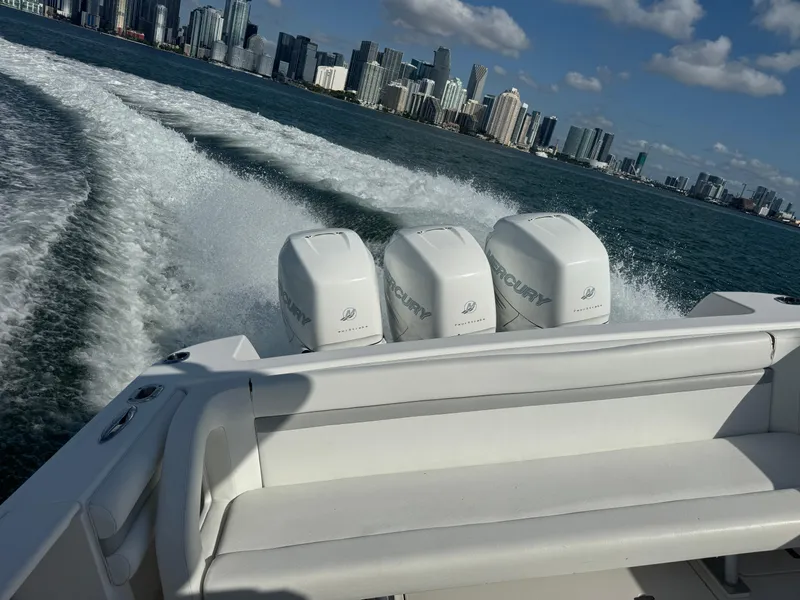 Slide: The Image of 2016 Intrepid 375 CC boat cruising with city skyline in background. - 31