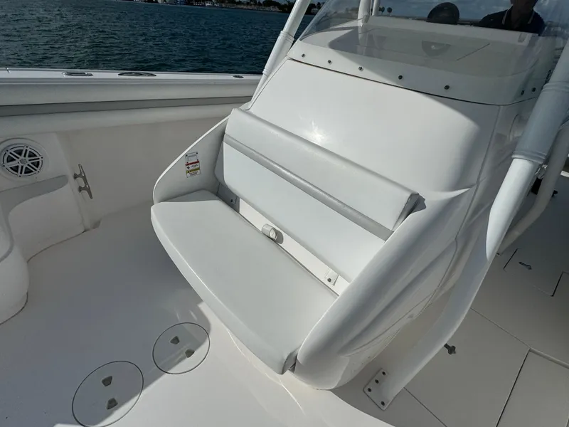 Slide: The Image of 2016 Intrepid 375 CC boat interior with white seating and ocean view. - 40