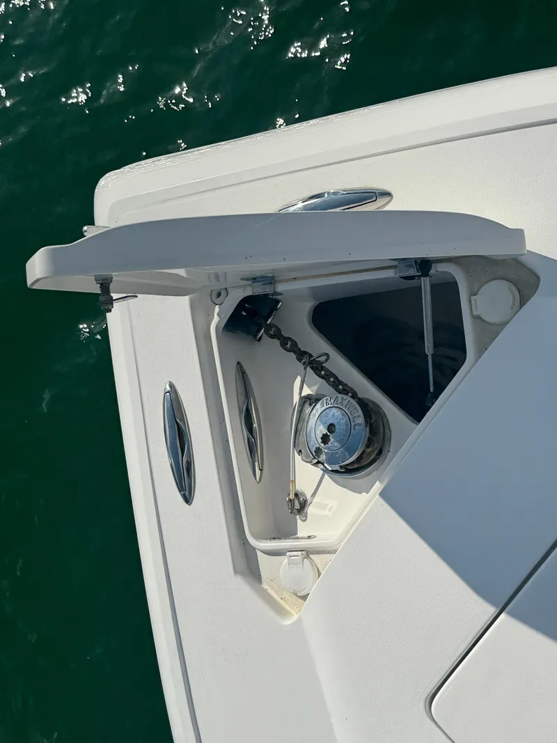 Slide: The Image of 2016 Intrepid 375 CC boat anchor compartment with open hatch, viewed from above. - 41