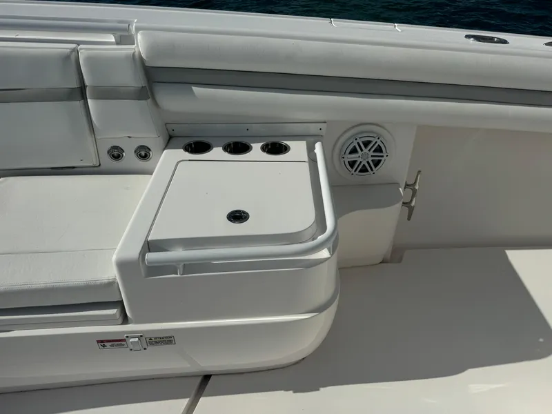 Slide: The Image of 2016 Intrepid 375 CC boat interior with seating and cup holders. - 46