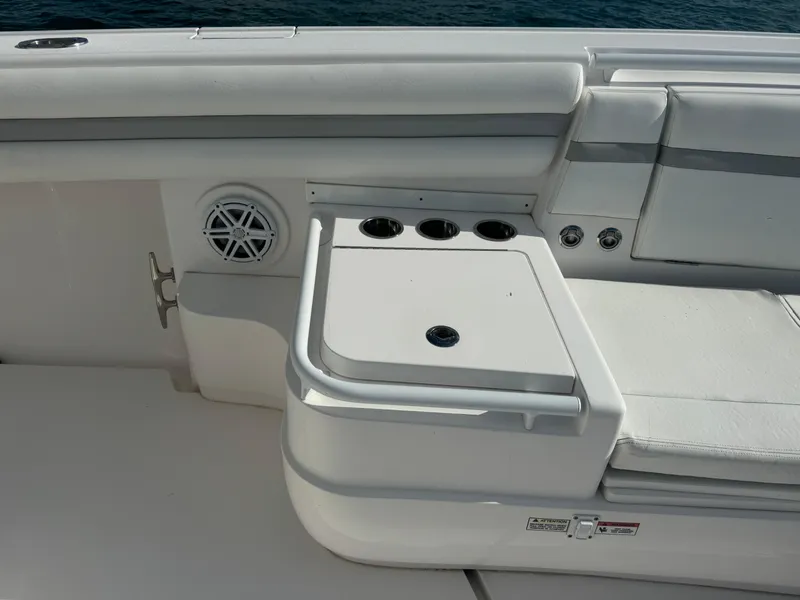 Slide: The Image of 2016 Intrepid 375 CC boat interior with seating and cup holders. - 47