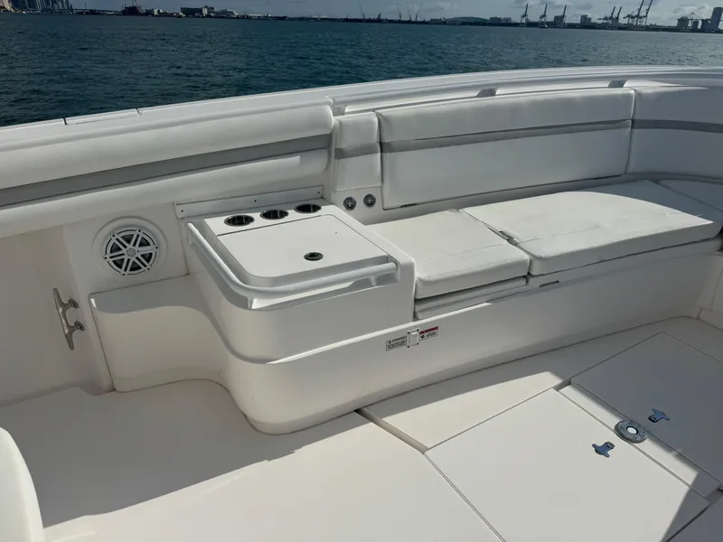 Slide: The Image of 2016 Intrepid 375 CC boat interior with white seating and cup holders. - 48