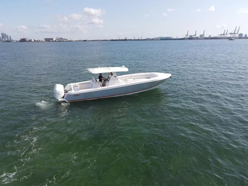 Slide: The Image of 2016 Intrepid 375 CC boat cruising on open water under a clear sky. - 5
