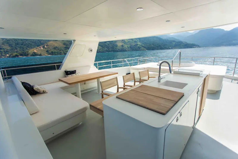 Slide: The Image of Luxurious 2027 Inace Explora 90 yacht deck with seating, dining area, and ocean view. - 14