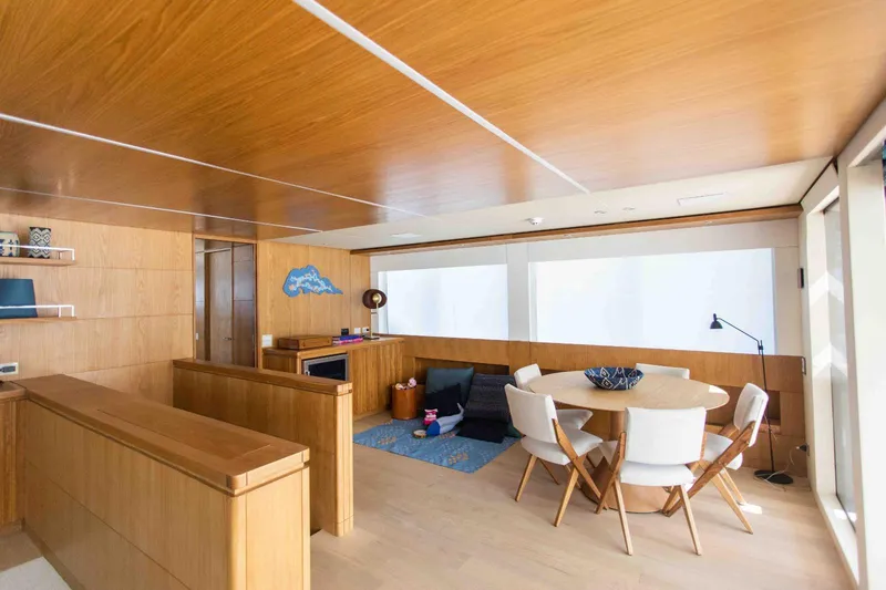 Slide: The Image of Luxurious interior of 2027 Inace Explora 90 yacht with modern dining area and wooden finishes. - 30