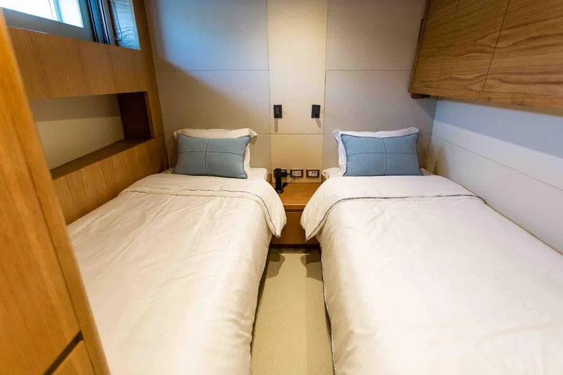 Slide: The Image of Twin cabin in 2027 Inace Explora 90 yacht, featuring modern design and cozy bedding. - 38