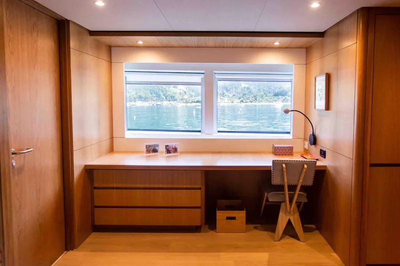 Slide: The Image of Luxurious Inace Explora 90 yacht interior with wooden desk and scenic window view, 2027 model. - 39