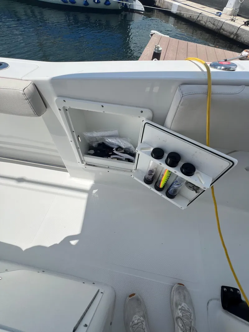 Slide: The Image of 2022 Sea Hunt Gamefish 30 Coffin Box boat with dual engines docked in a marina. - 11