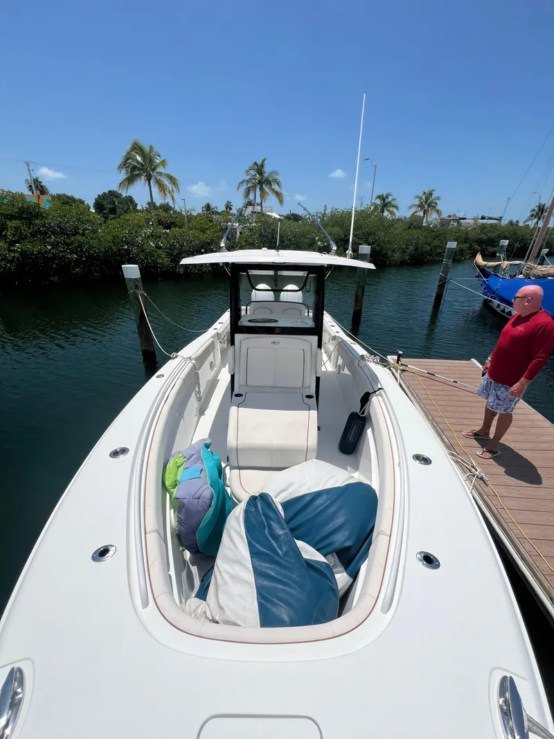 Slide: The Image of 2022 Sea Hunt Gamefish 30 Coffin Box boat docked, featuring spacious seating and modern design. - 16