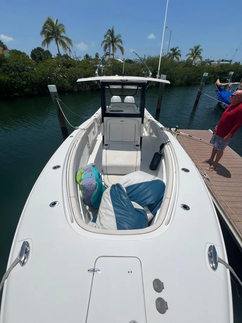 Slide: The Image of 2022 Sea Hunt Gamefish 30 Coffin Box boat docked, featuring spacious seating and storage. - 17