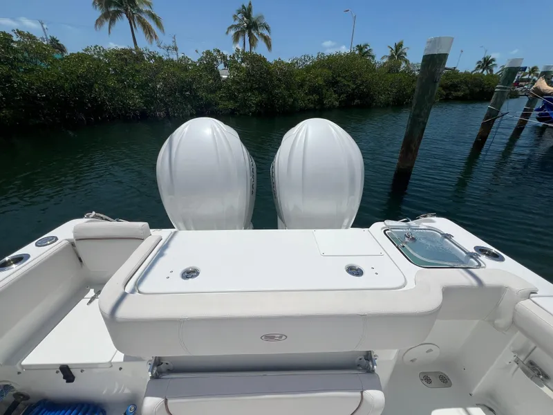 Slide: The Image of 2022 Sea Hunt Gamefish 30 Coffin Box boat docked, open storage, sunny day. - 23