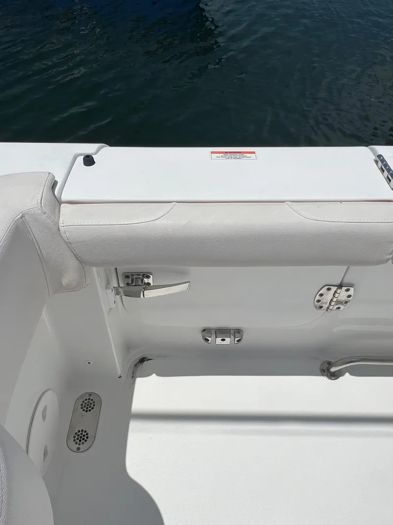 Slide: The Image of 2022 Sea Hunt Gamefish 30 Coffin Box boat interior with open storage compartment. - 25