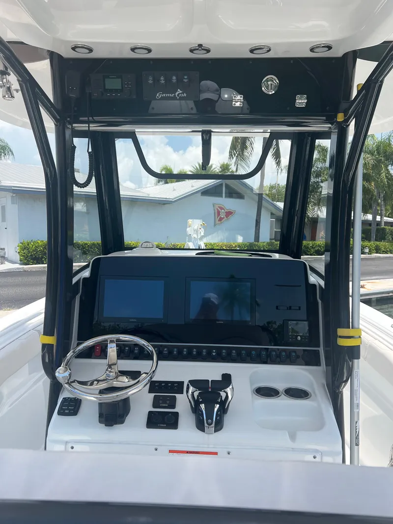 Slide: The Image of 2022 Sea Hunt Gamefish 30 Coffin Box boat docked, surrounded by other vessels. - 4