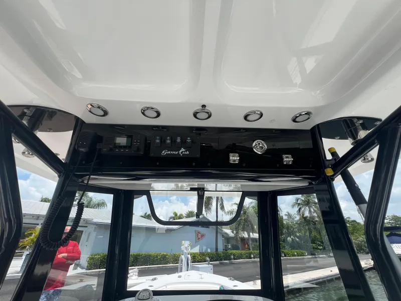 Slide: The Image of 2022 Sea Hunt Gamefish 30 Coffin Box boat docked under a sunny sky. - 5