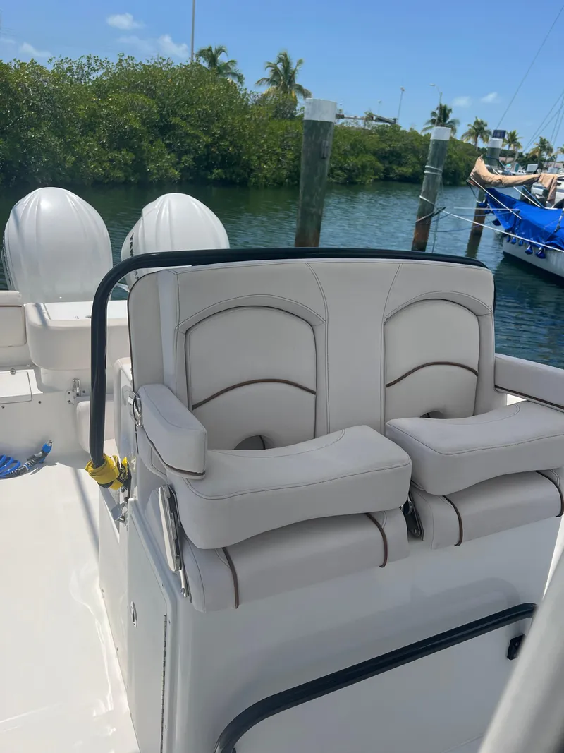 Slide: The Image of 2022 Sea Hunt Gamefish 30 Coffin Box boat docked under a sunny sky. - 6