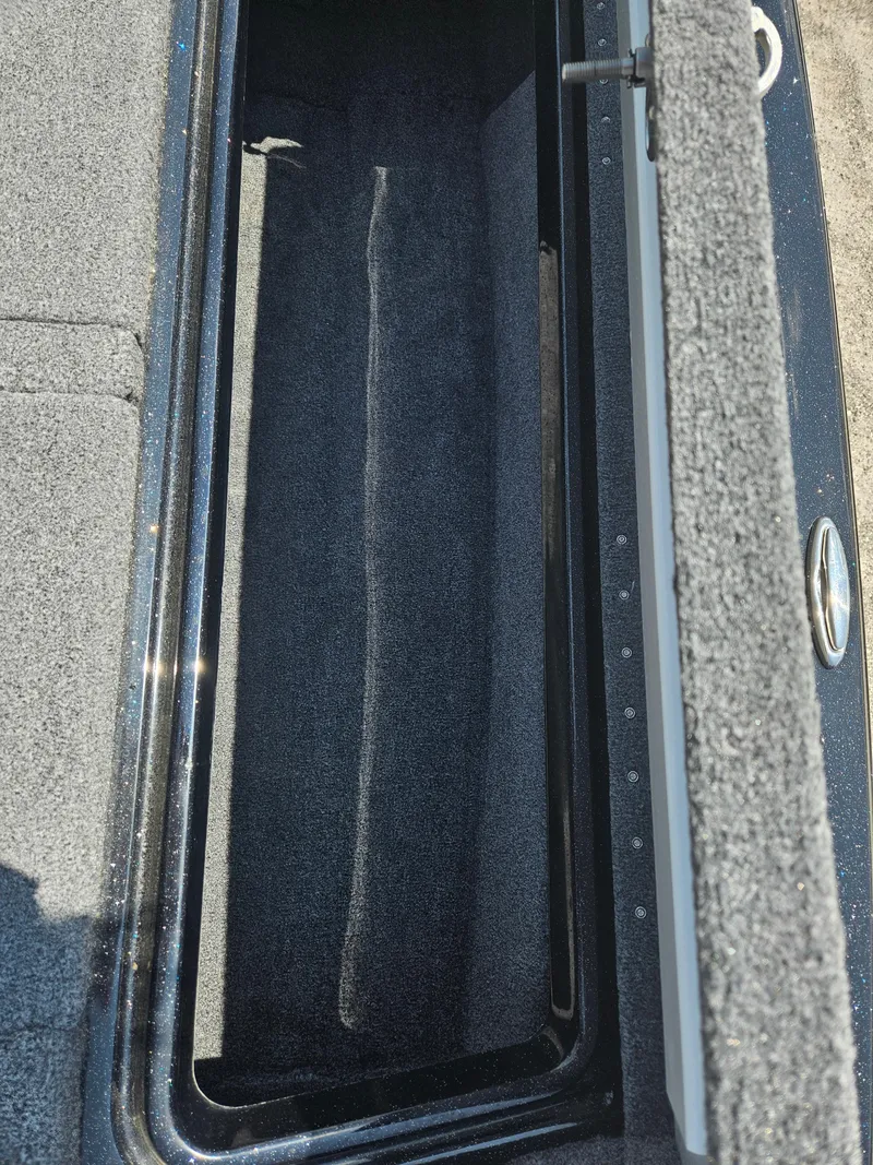 Slide: The Image of 2023 Phoenix 721 ProXP boat storage compartment with carpeted interior. - 10
