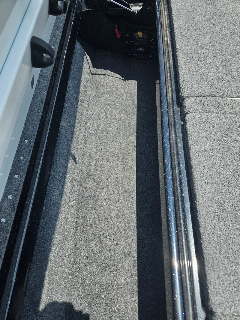 Slide: The Image of 2023 Phoenix 721 ProXP boat storage compartment with carpeted interior. - 11