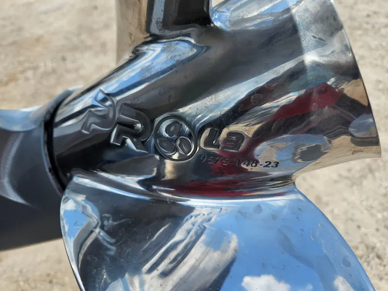 Slide: The Image of Close-up of a shiny metal propeller on a 2023 Phoenix 721 ProXP boat. - 12
