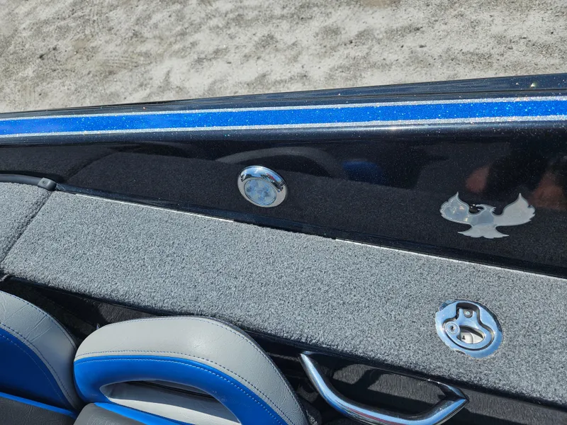 Slide: The Image of 2023 Phoenix 721 ProXP boat interior with blue and gray seating, sleek design, and emblem detail. - 14