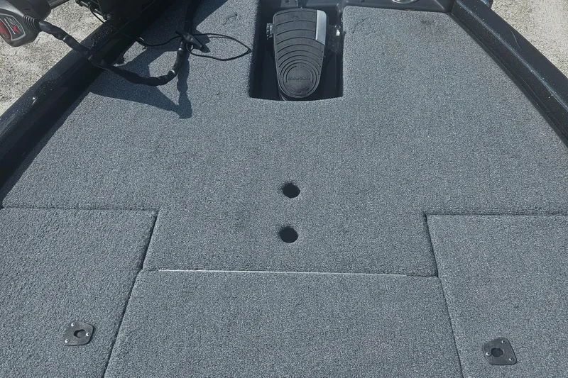 Slide: The Image of 2023 Phoenix 721 ProXP boat deck with gray carpet and pedal controls. - 16