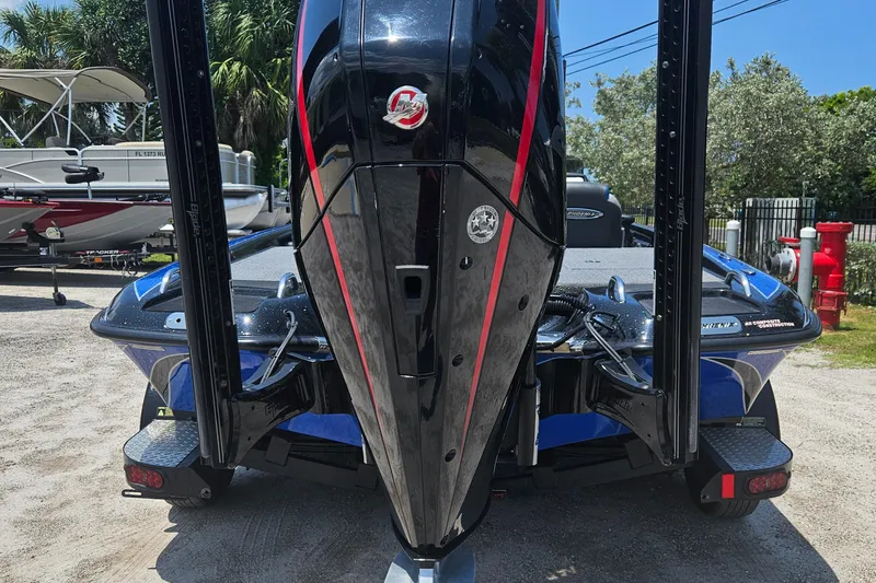 Slide: The Image of 2023 Phoenix 721 ProXP boat, rear view, parked outdoors on a sunny day. - 23