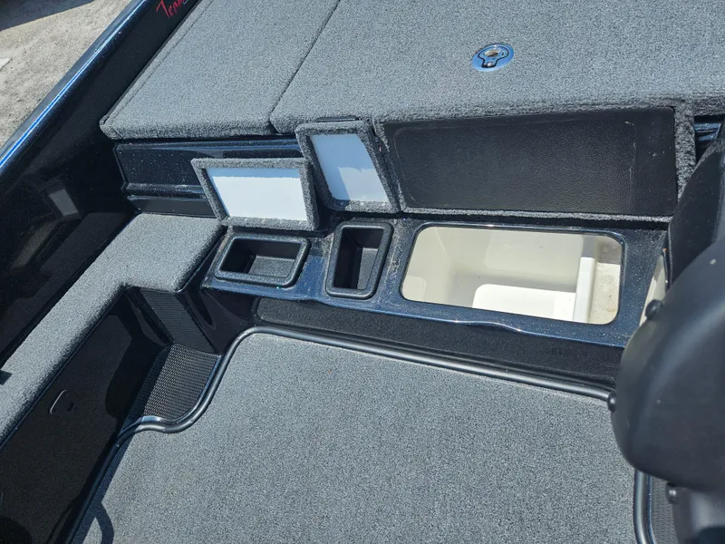 Slide: The Image of 2023 Phoenix 721 ProXP boat interior with storage compartments and carpeted flooring. - 7