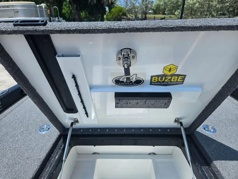 Slide: The Image of 2023 Phoenix 721 ProXP boat storage compartment with tackle and Buzbe stickers. - 8