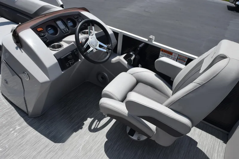 Slide: The Image of 2022 Bennington SX 23 Stern Lounge boat interior with steering wheel and captain's chair. - 13