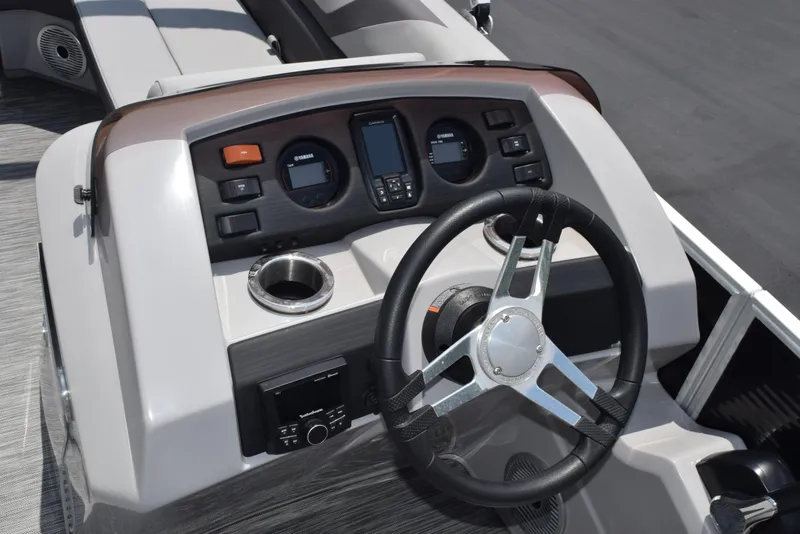 Slide: The Image of 2022 Bennington SX 23 Stern Lounge dashboard with steering wheel and controls. - 14