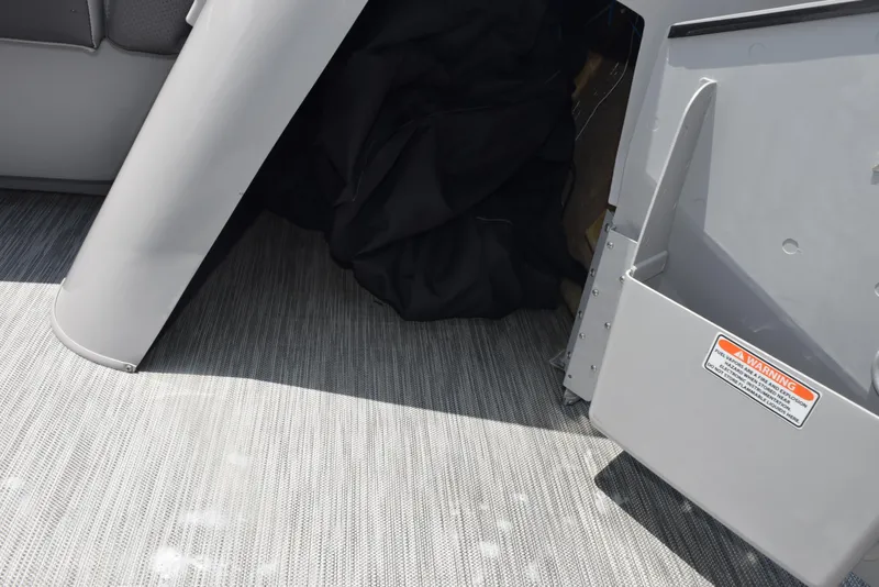 Slide: The Image of Interior view of 2022 Bennington SX 23 Stern Lounge with gray flooring and storage compartment. - 18