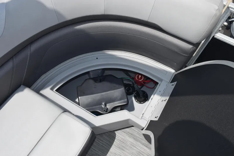 Slide: The Image of 2022 Bennington SX 23 Stern Lounge storage compartment with battery and wiring. - 19