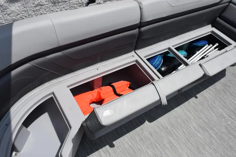 Slide: The Image of 2022 Bennington SX 23 Stern Lounge storage compartments with life jacket and accessories. - 20