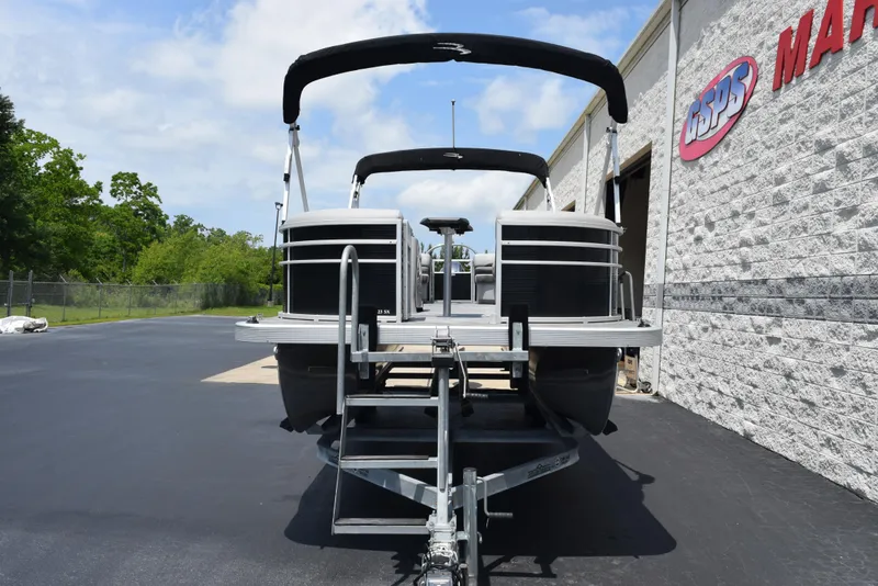 Slide: The Image of 2022 Bennington SX 23 Stern Lounge pontoon boat on trailer, parked outside dealership. - 3
