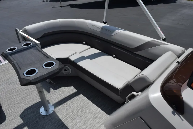Slide: The Image of 2022 Bennington SX 23 Stern Lounge with gray seating and cupholder table. - 9