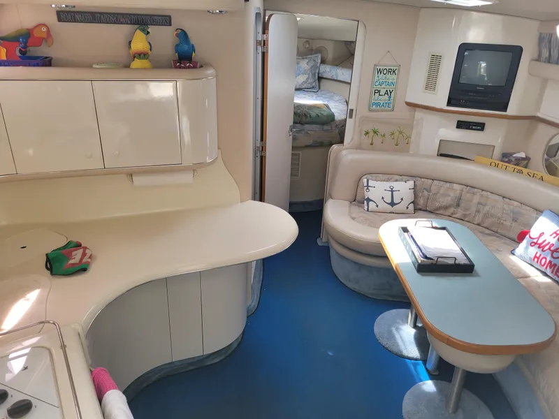 Slide: The Image of Interior of 1995 Sea Ray 370 Sundancer yacht with cozy seating and nautical decor. - 16