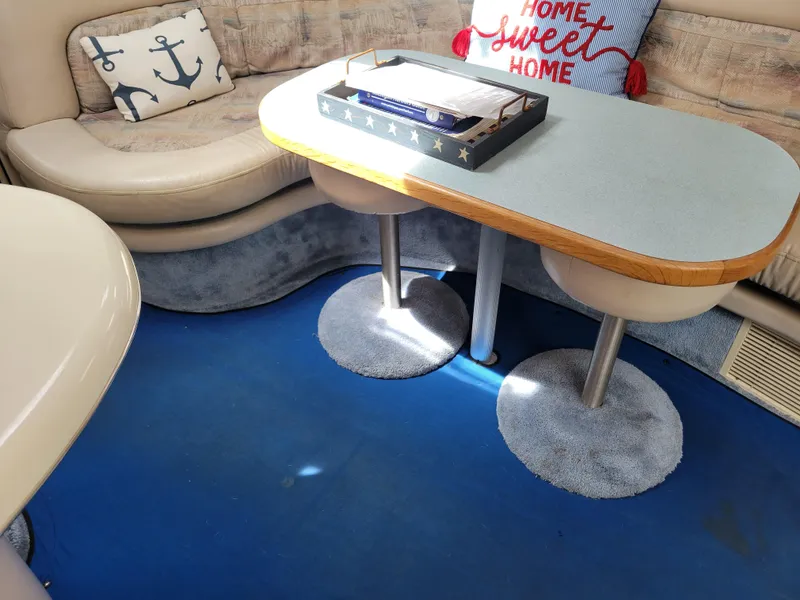 Slide: The Image of Interior of 1995 Sea Ray 370 Sundancer with nautical-themed decor and cozy seating. - 18