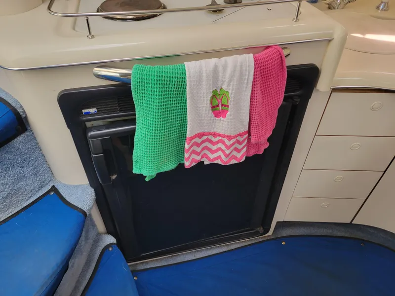 Slide: The Image of Interior of 1995 Sea Ray 370 Sundancer with colorful towels on a cabinet. - 21