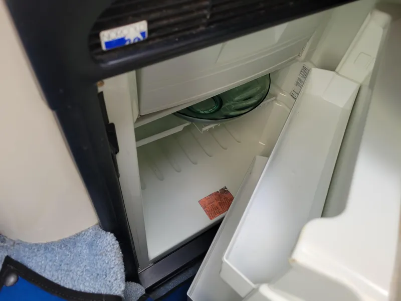 Slide: The Image of Open refrigerator inside a 1995 Sea Ray 370 Sundancer boat cabin. - 22