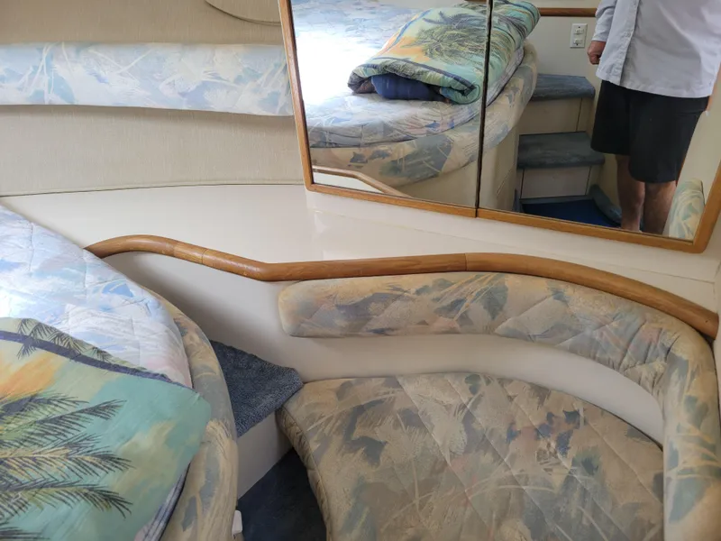 Slide: The Image of Interior of 1995 Sea Ray 370 Sundancer with patterned upholstery and mirrored wall. - 27