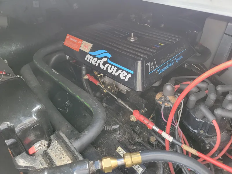 Slide: The Image of MerCruiser engine in a 1995 Sea Ray 370 Sundancer boat, showcasing mechanical components. - 31