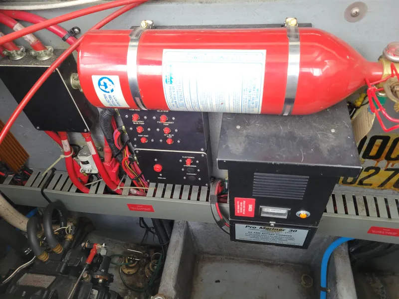 Slide: The Image of Engine compartment of 1995 Sea Ray 370 Sundancer with fire extinguisher and electrical components. - 32