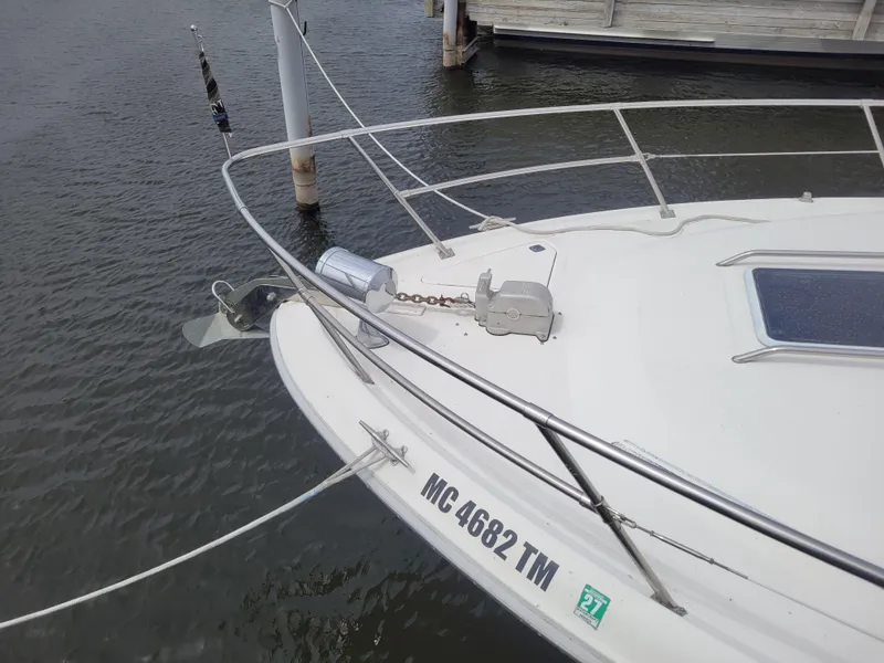 Slide: The Image of 1995 Sea Ray 370 Sundancer boat docked, showing bow and anchor details. - 33