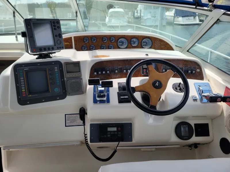 Slide: The Image of 1995 Sea Ray 370 Sundancer helm with navigation equipment and steering wheel. - 7