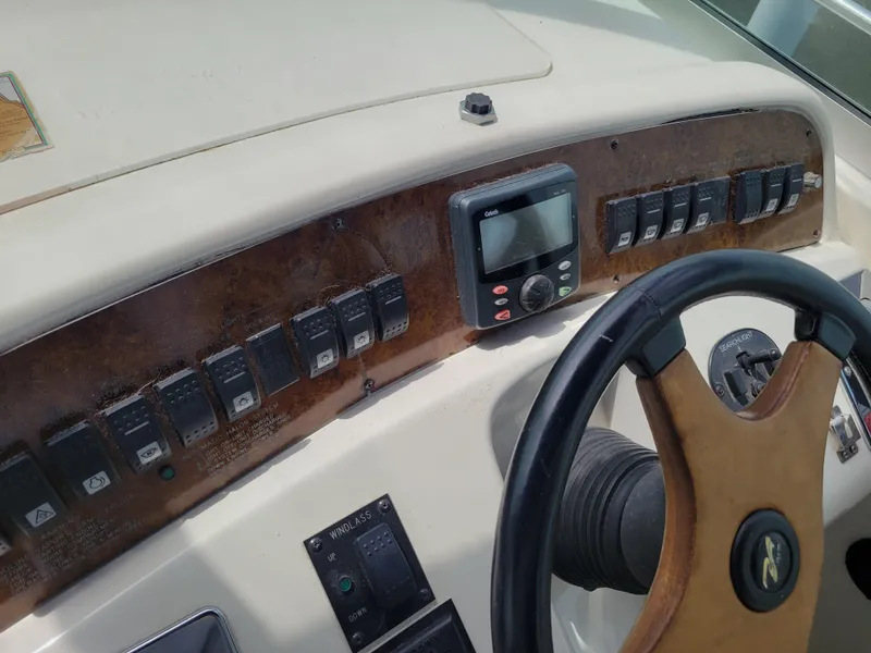 Slide: The Image of Control panel of a 1995 Sea Ray 370 Sundancer boat with steering wheel and switches. - 8